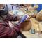 This shows me carving the dried gourd. I am adding a decorative wavy edge with a stipled texture to the top of the gourd. 